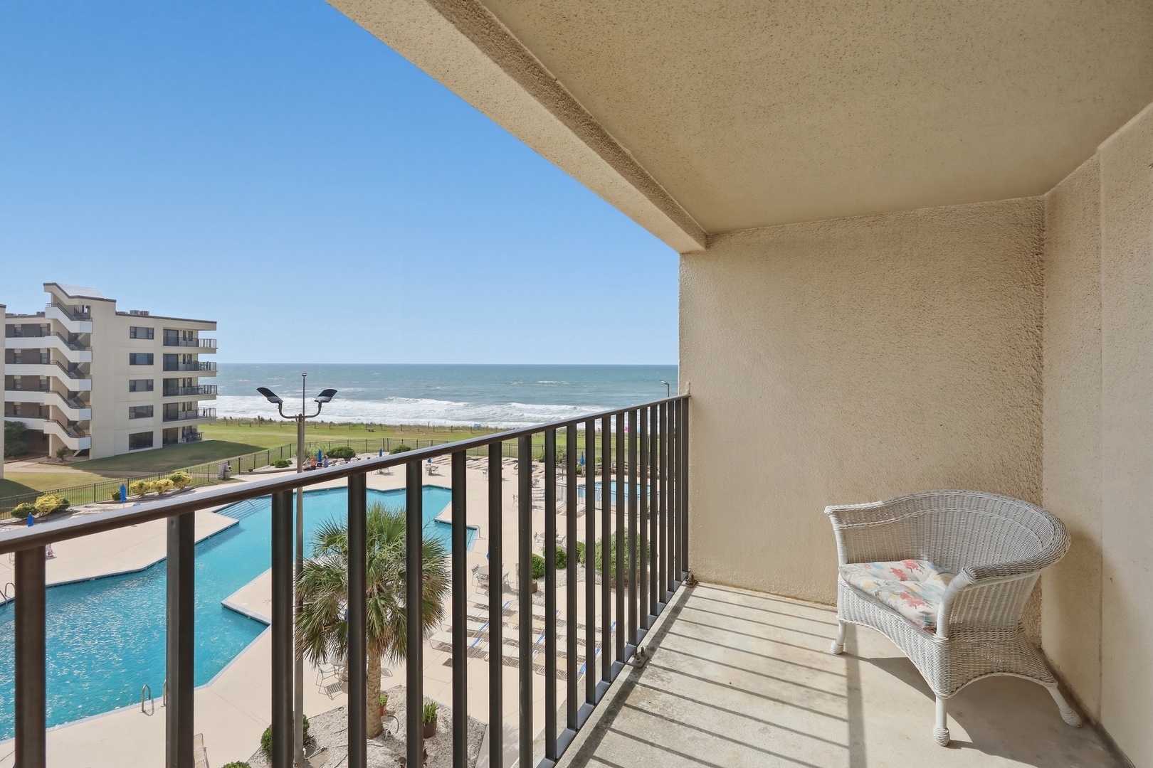Relax on your private balcony overlooking the pool and sparkling ocean. Feel the coastal breeze as you unwind with stunning water views just steps from your door.
