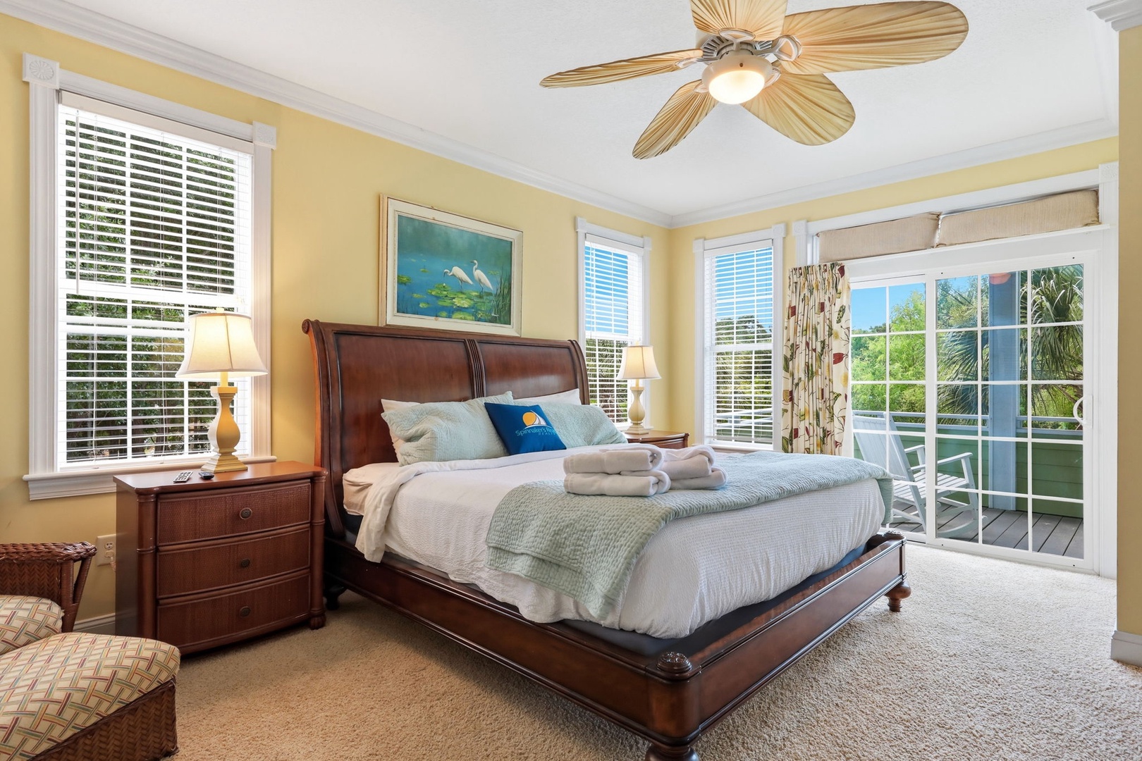 Sink into crisp linens and coastal calm in your sun-drenched bedroom, where French doors open to your private balcony and plush towels await your tropical escape.