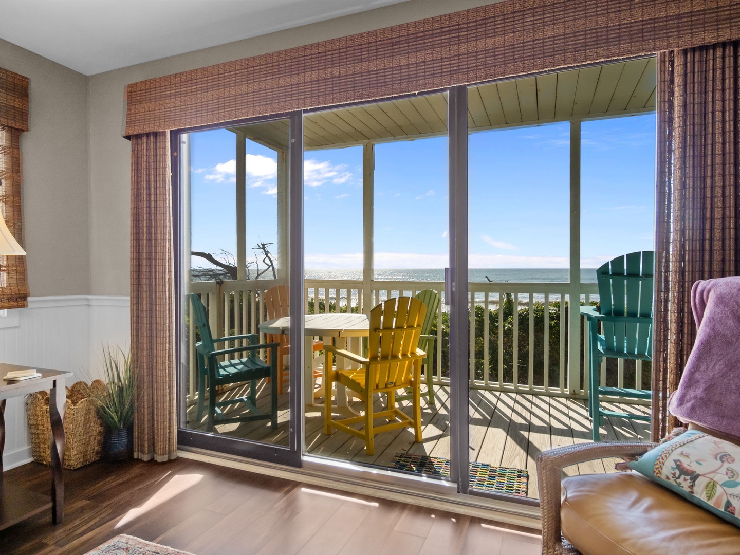Step onto your private balcony where colorful beach chairs await, offering stunning sea views perfect for morning coffee or sunset relaxation.