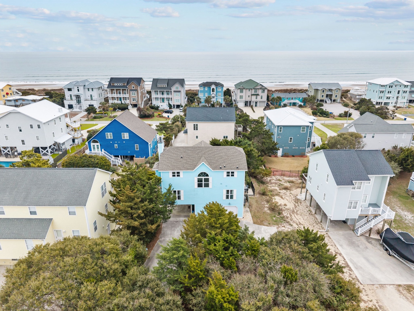 Charming coastal vacation home community with colorful beach houses just steps from the ocean shore.