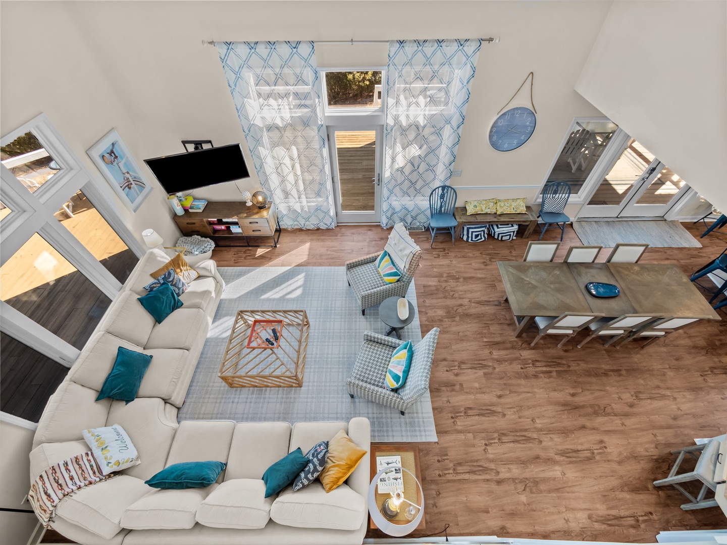 Your airy, modern living space features soaring ceilings, comfortable seating, and abundant natural light streaming through skylights and windows.