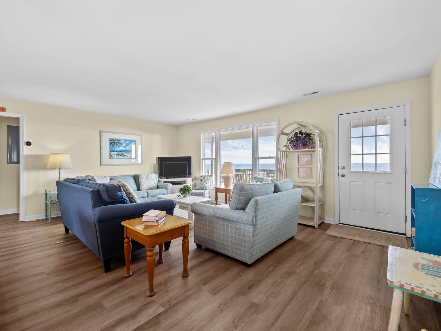 Sink into plush seating where coastal charm meets comfort, with ocean views framing your perfect retreat moments.