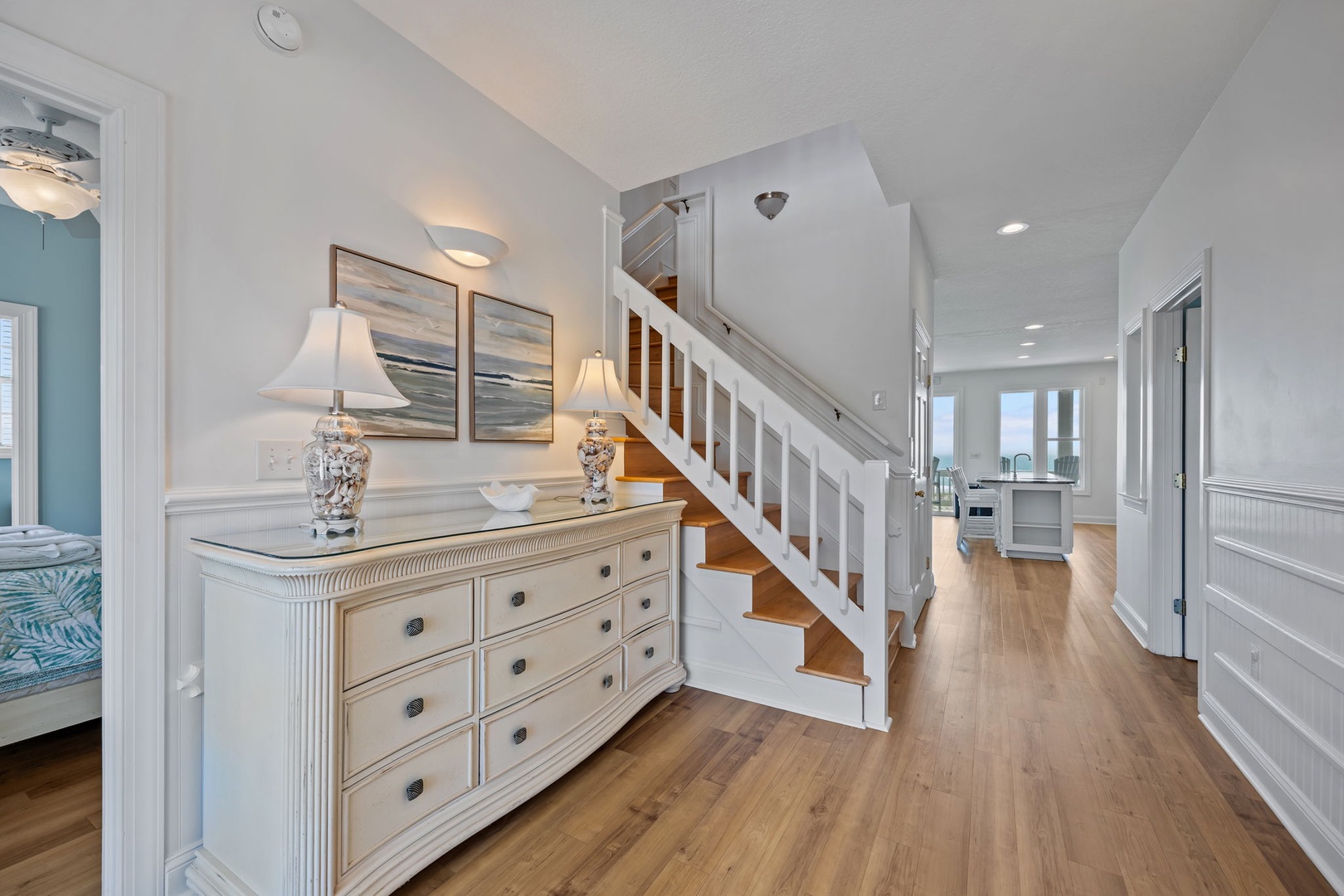 Step into your elegant coastal retreat with gleaming hardwood floors and crisp white details that create a fresh, airy atmosphere.