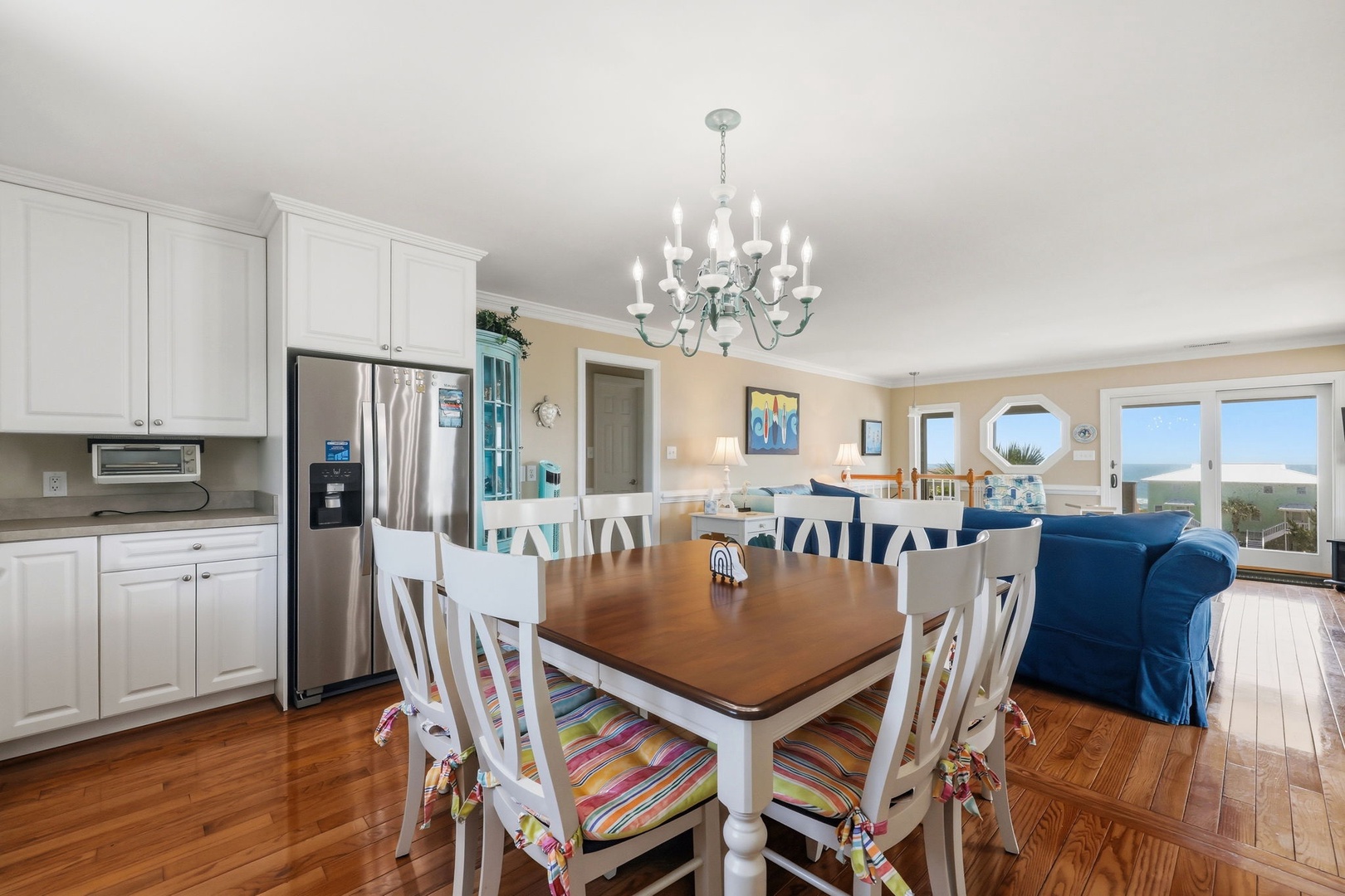 Imagine preparing meals in this bright open kitchen while gazing at stunning ocean views. The spacious dining area flows into a cozy living room—perfect for gathering with loved ones after a day at the beach.