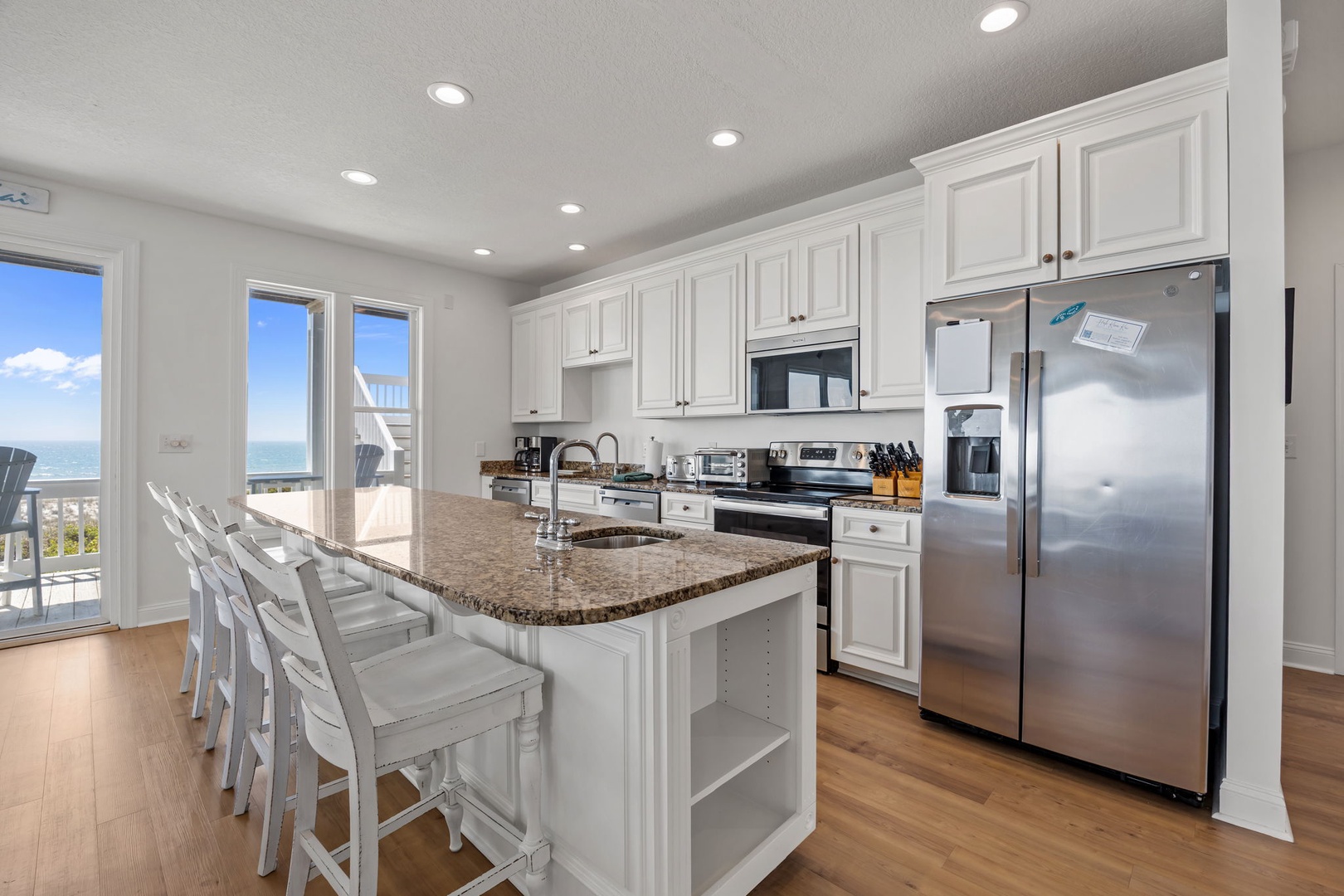Your gourmet kitchen features granite counters, stainless appliances, and a breakfast bar where you can sip morning coffee while enjoying stunning ocean views.
