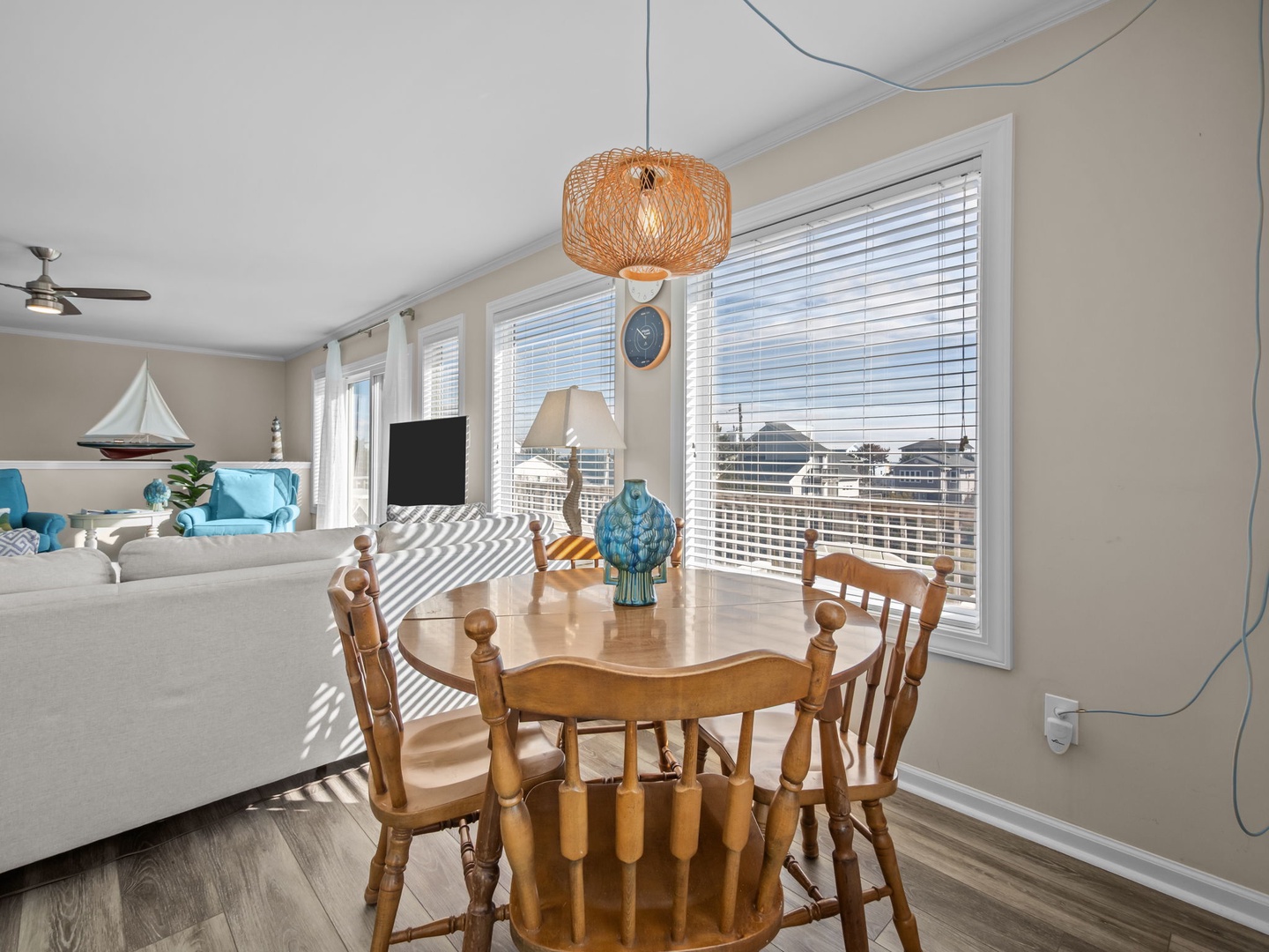 Gather around your warm wooden dining table while enjoying stunning city views through expansive windows that flood the space with natural light.