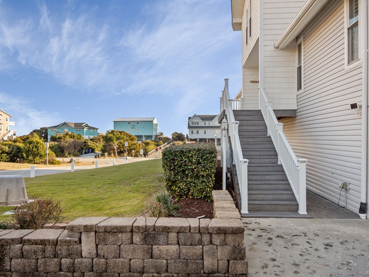 Coastal neighborhood setting with colorful beach houses and well-maintained landscaping creating a charming seaside community atmosphere.