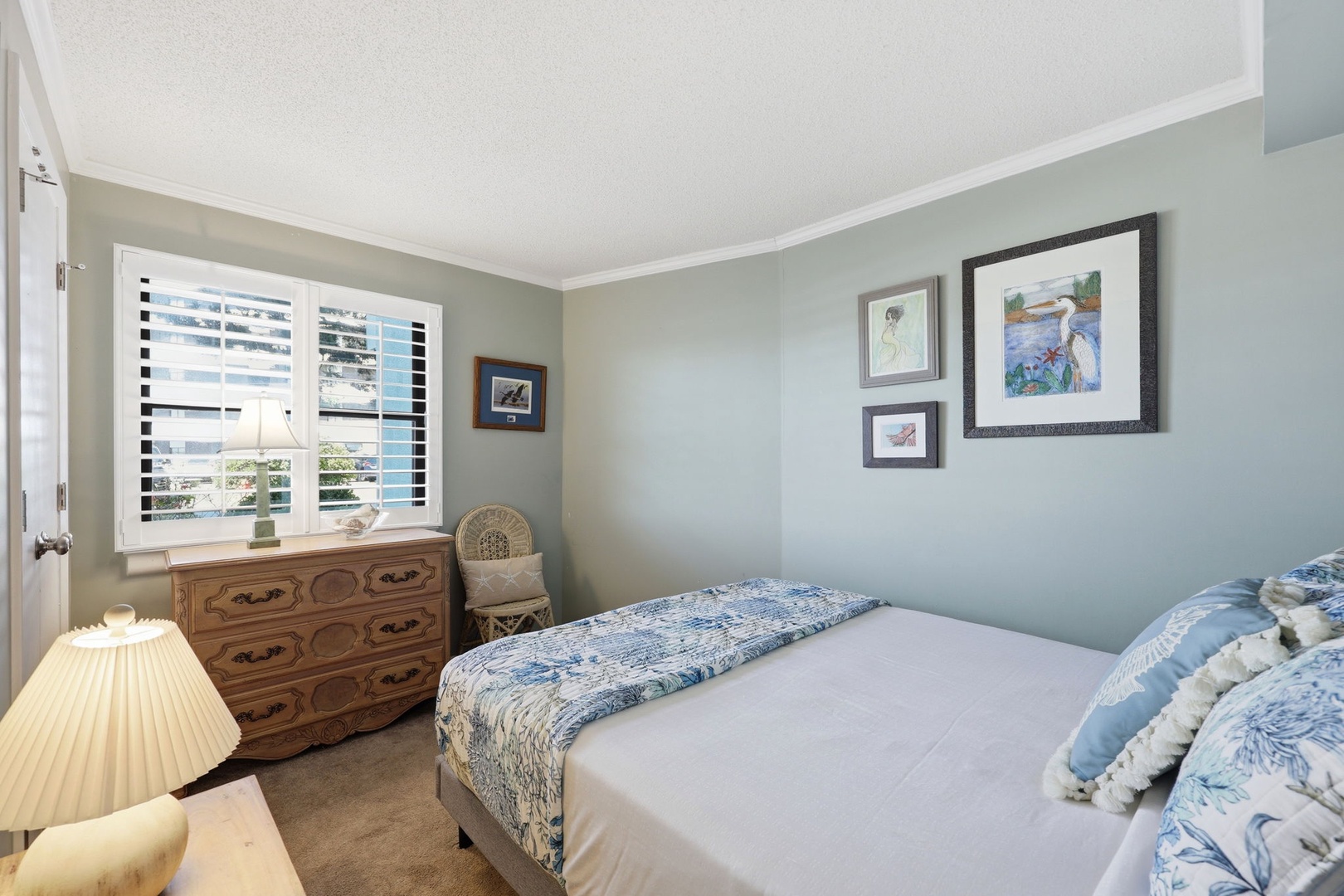 Relax in this serene coastal bedroom, where soft blues and crisp linens invite restful nights after your day exploring the area.