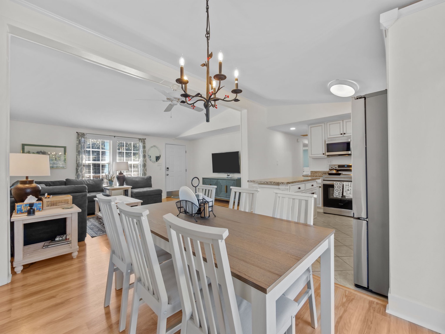 Your open-concept retreat seamlessly blends modern comfort with coastal charm, featuring a fully equipped kitchen and cozy living area perfect for gathering.