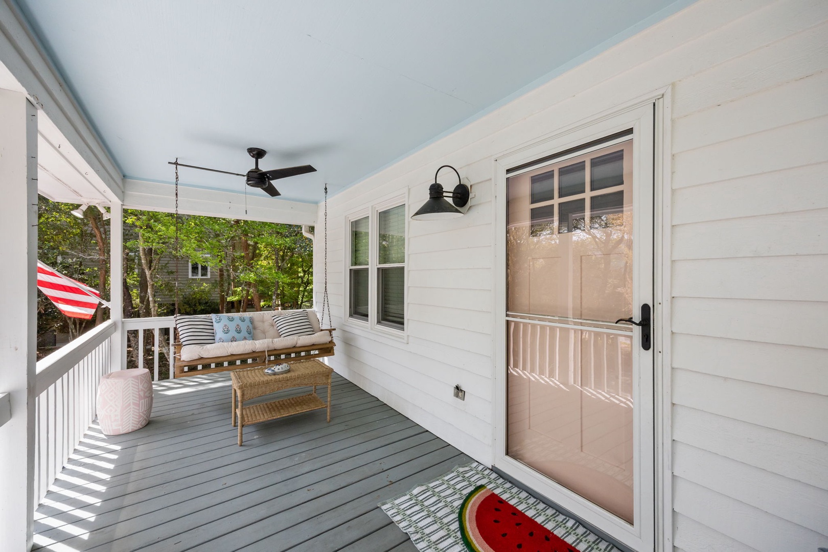 Relax on your charming covered porch with comfortable swing seating and gentle ceiling fan breezes.