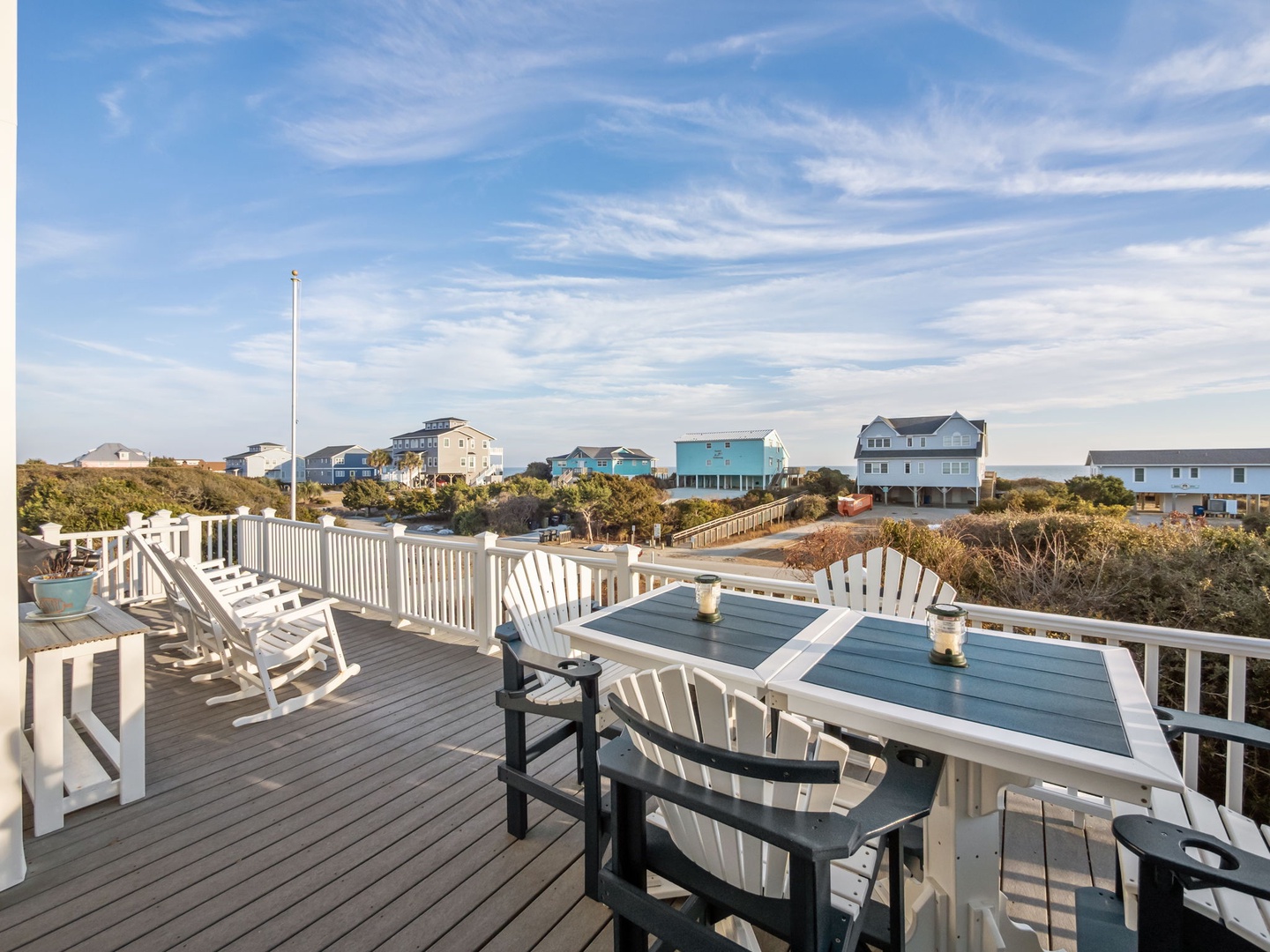 Spacious deck with comfortable seating where you can dine al fresco and unwind while taking in coastal views.