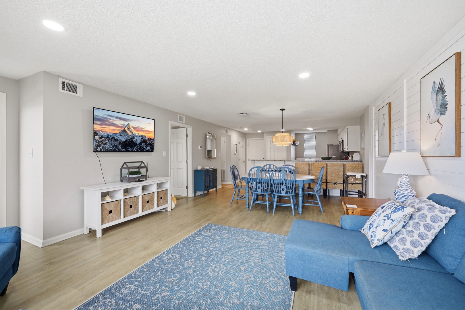 Settle into this spacious, light-filled living area where you'll find comfort and style. Relax on the cozy sofa, gather at the dining table, and enjoy modern amenities in your bright, inviting home away from home.