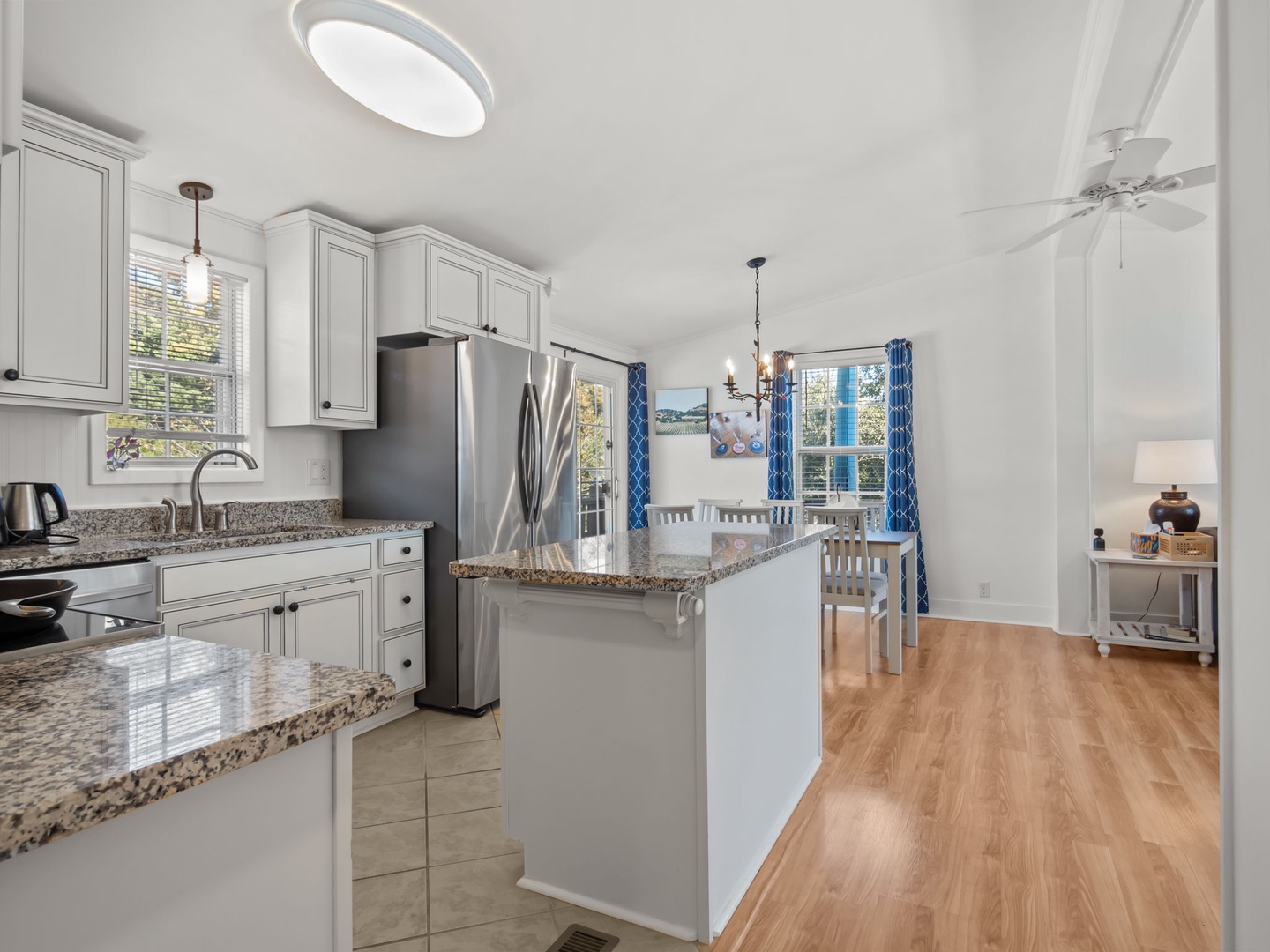 Your bright kitchen features granite countertops, stainless steel appliances, and flows seamlessly into the dining area.