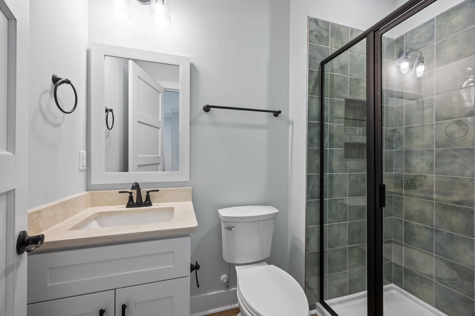 Step into your pristine bathroom featuring a luxurious glass shower, elegant vanity, and modern finishes for your comfort.