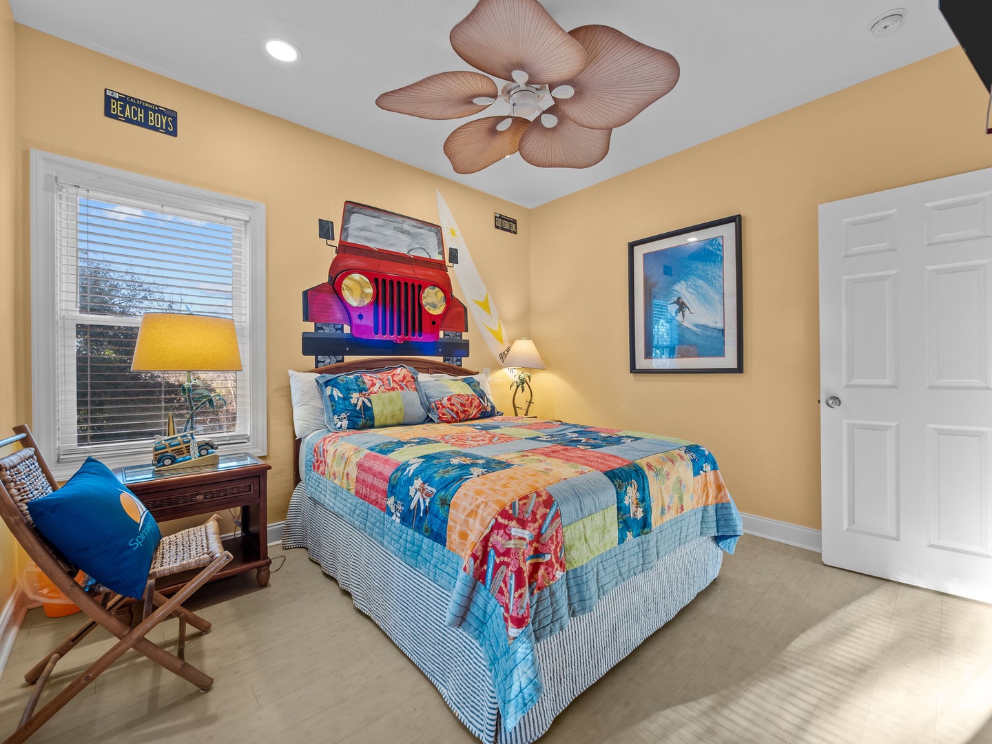 Your beach-themed bedroom features colorful surf bedding and fun tropical ceiling fan for dreamy seaside nights.