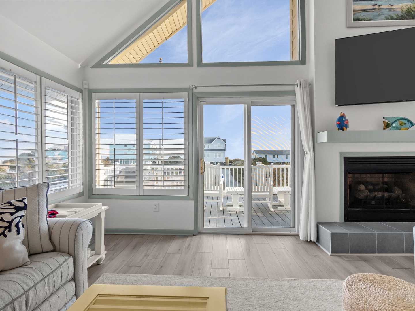 Relax in your bright living room with soaring ceilings, cozy fireplace, and sliding doors opening to your private balcony overlooking the neighborhood.