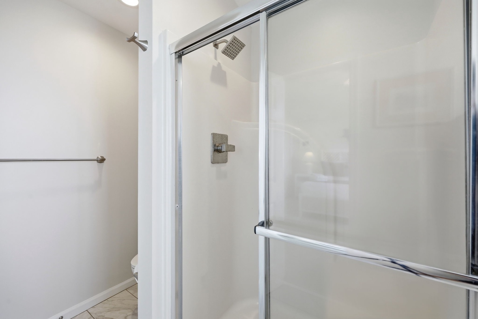 Step into your private glass-enclosed shower with rainfall showerhead—perfect for refreshing after a day of adventure or relaxing before bed.
