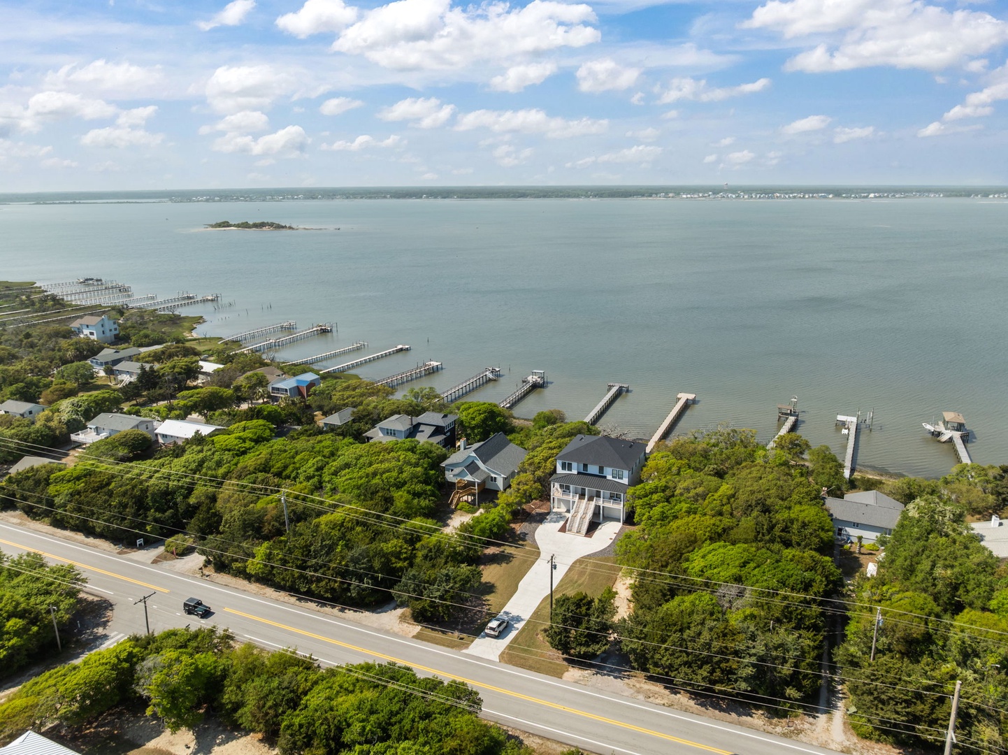 Aerial view of waterfront property showcasing the beautiful bay location with private dock access and peaceful coastal setting.