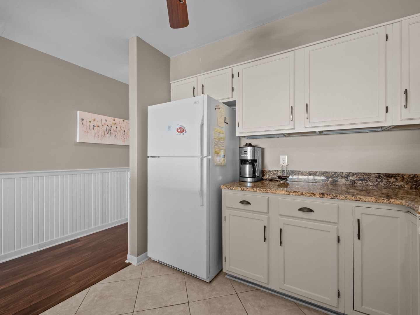 Your fully equipped kitchen awaits with granite countertops, white appliances, and plenty of cabinet space for all your culinary adventures.