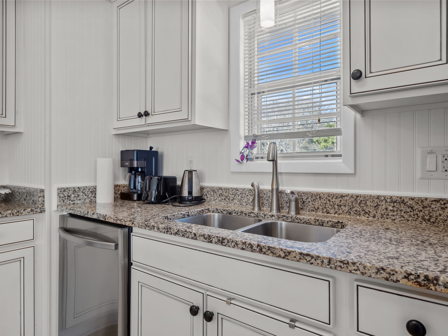 Your fully equipped kitchen features granite counters, modern appliances, and a coffee maker ready for your morning routine.