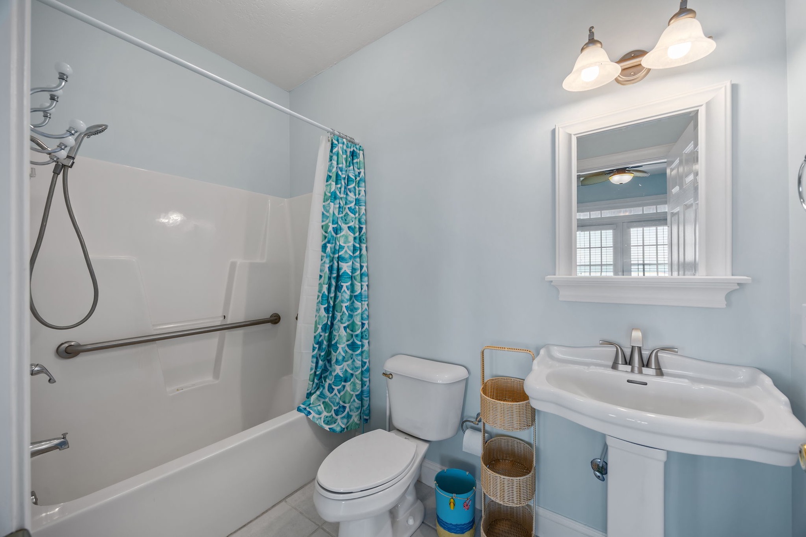 Fresh up in your private bathroom with modern fixtures, soothing blue tones, and thoughtful accessibility features for ultimate comfort.