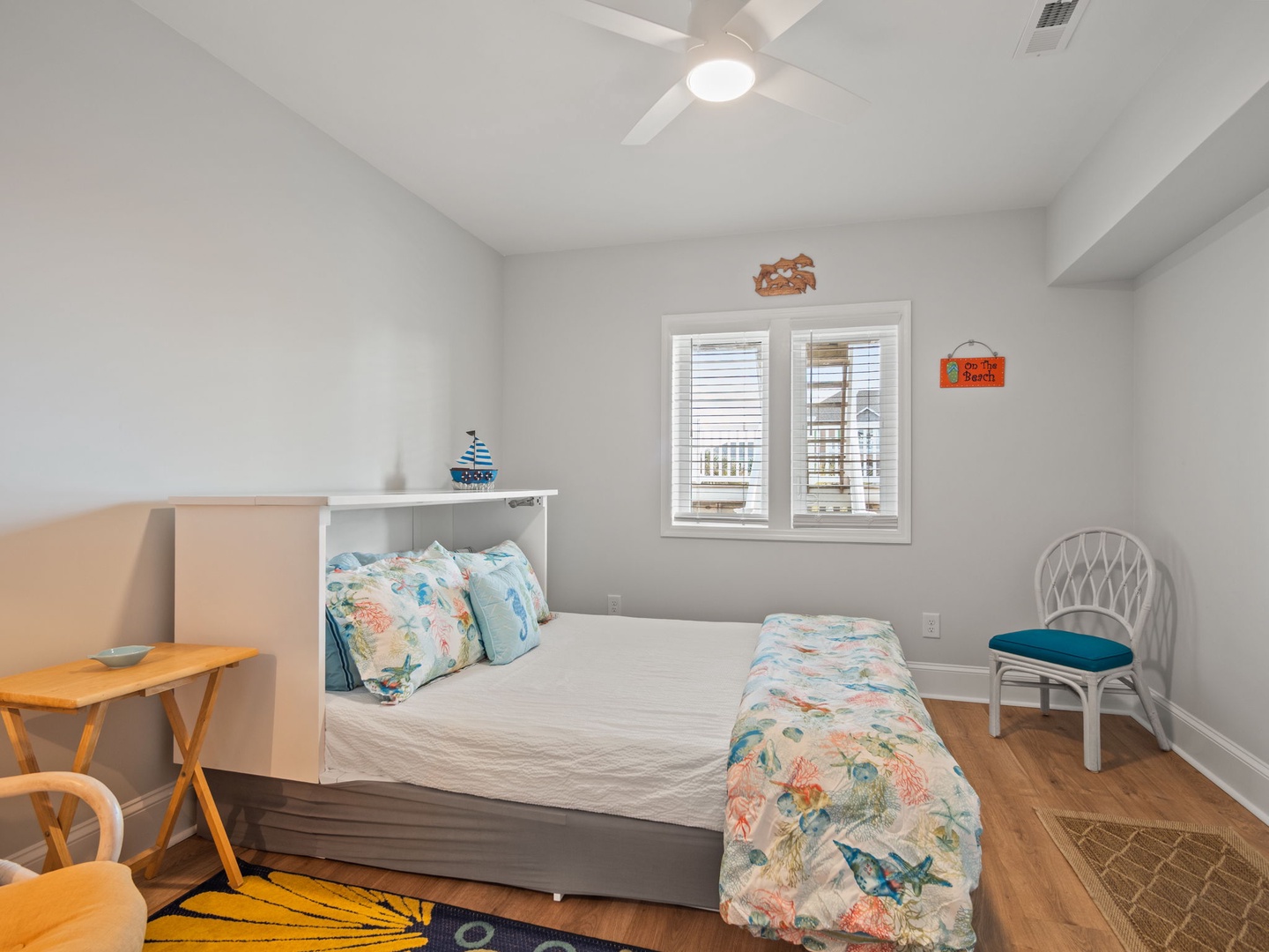 Your cozy bedroom features ocean-inspired linens and coastal charm, perfect for peaceful nights after beach days.