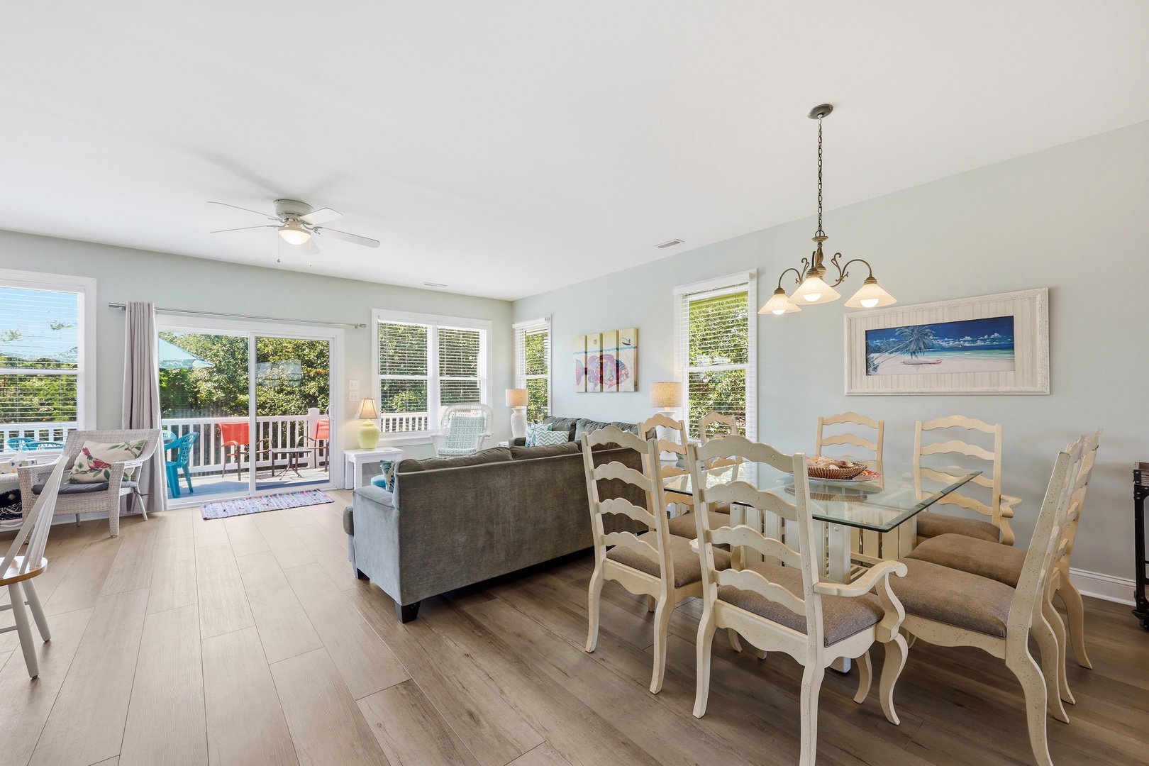 Imagine relaxing in this bright, open space where the living and dining areas flow together seamlessly. Sunlight pours through large windows, inviting you to step onto the deck and soak in the view.