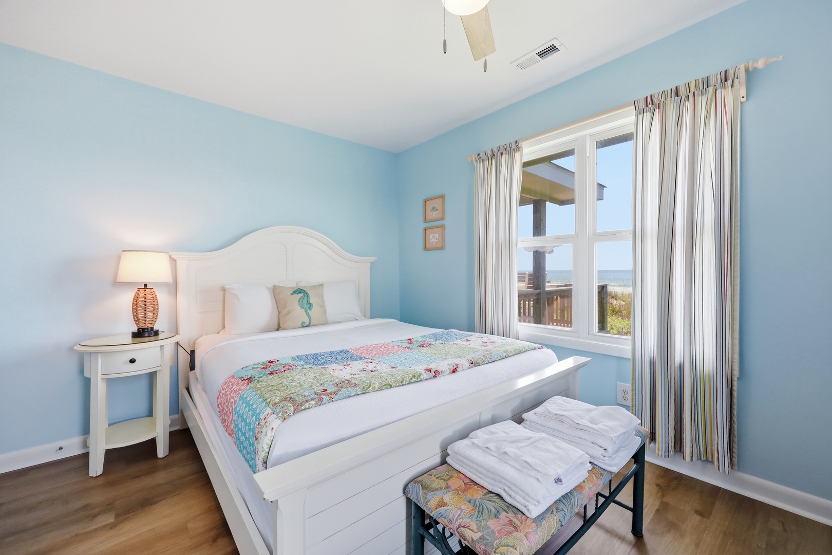 Drift off in soft coastal blues with a plush bed and peek at ocean views just outside your window. Your beach getaway begins here.