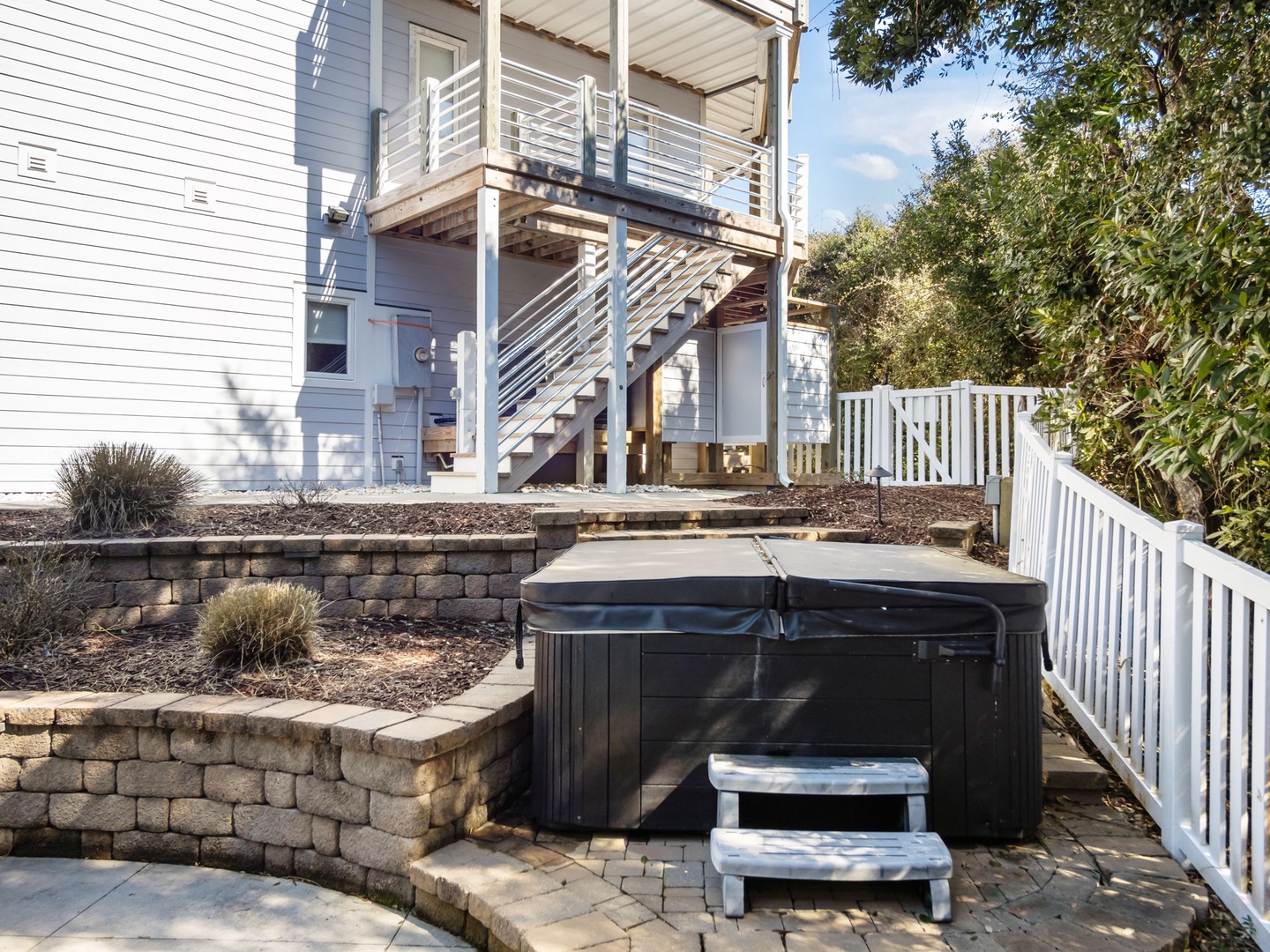 Soak your cares away in your private hot tub, surrounded by beautiful stone landscaping and peaceful outdoor space.