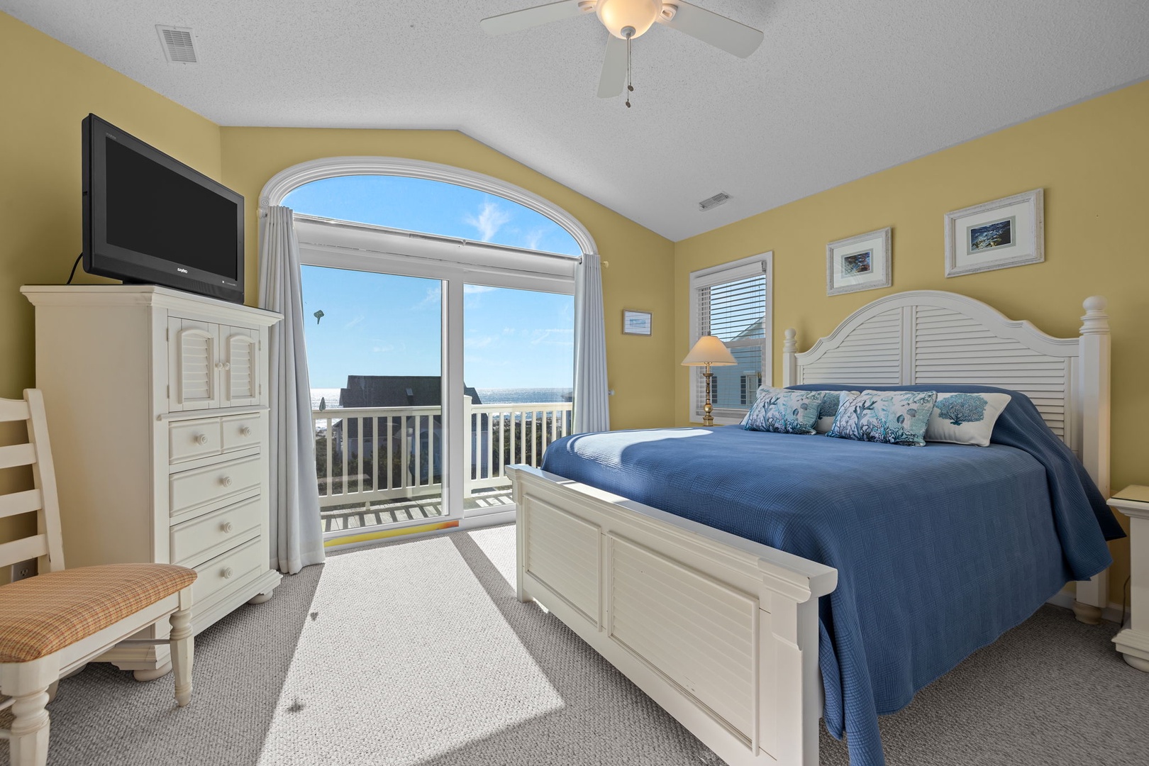 Wake up to stunning ocean views from your comfortable bed, with coastal breezes flowing through arched windows and a private balcony just steps away.