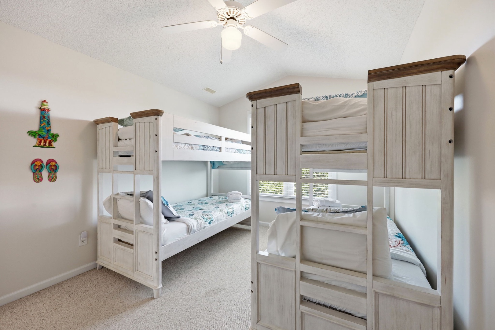 Your kids will love this cozy bunk room with two comfortable twin beds and playful beach-themed décor. A ceiling fan keeps the space cool and inviting after a fun-filled day.
