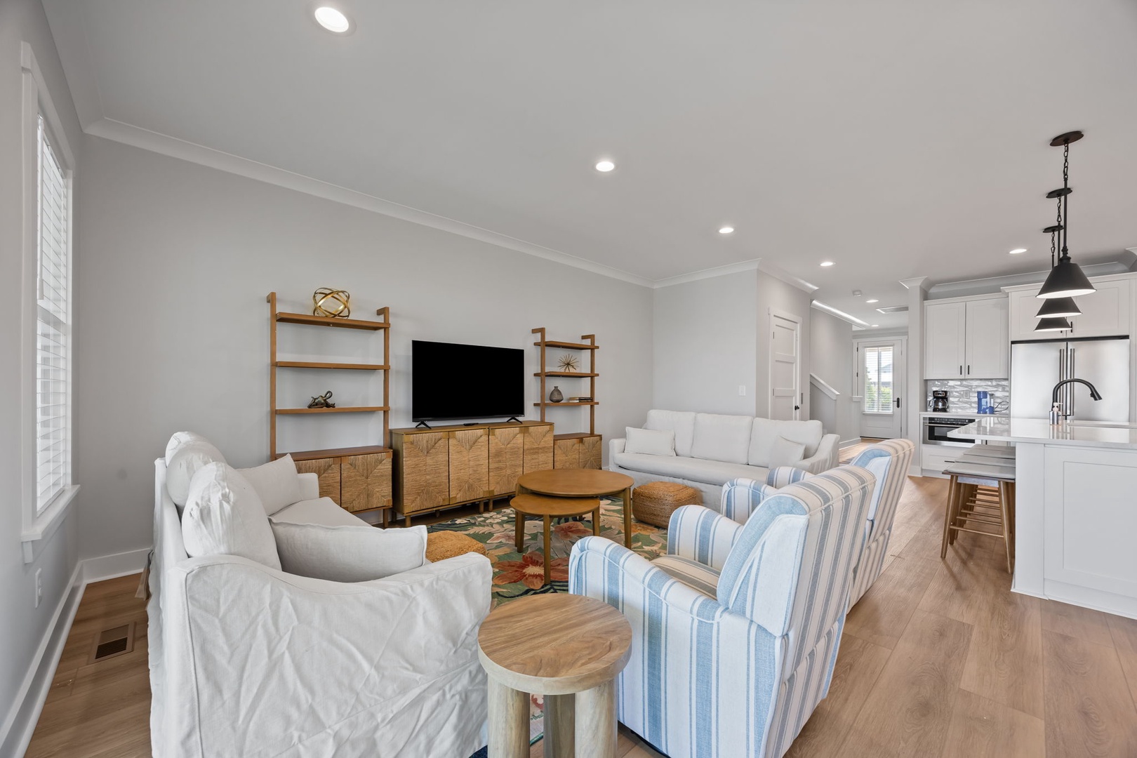 Relax in your bright, open living space with modern furnishings, entertainment center, and seamless flow to the fully-equipped kitchen.