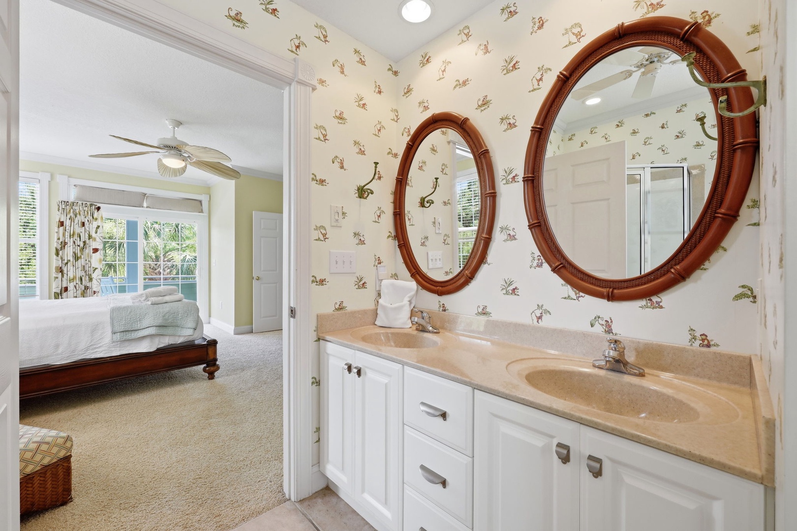 Refresh in your charming en-suite bathroom featuring double sinks and unique tropical mirrors before retiring to your airy bedroom with garden views.