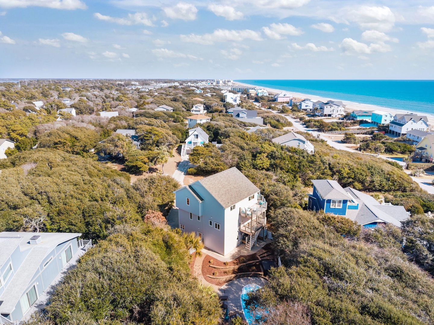 Elevated coastal home nestled among native vegetation, just minutes from pristine beaches and turquoise waters.