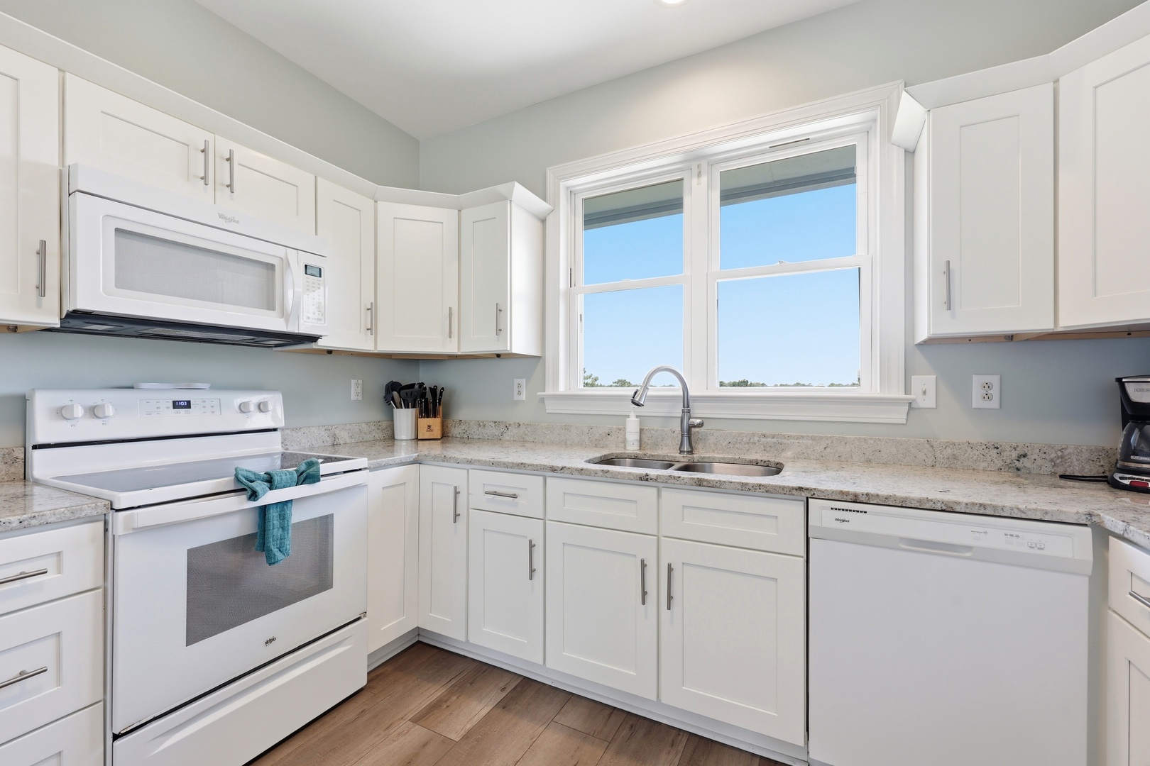 Your bright, fully-equipped kitchen offers everything you need to prepare delicious meals, with granite countertops, modern appliances, and natural light streaming through the windows.