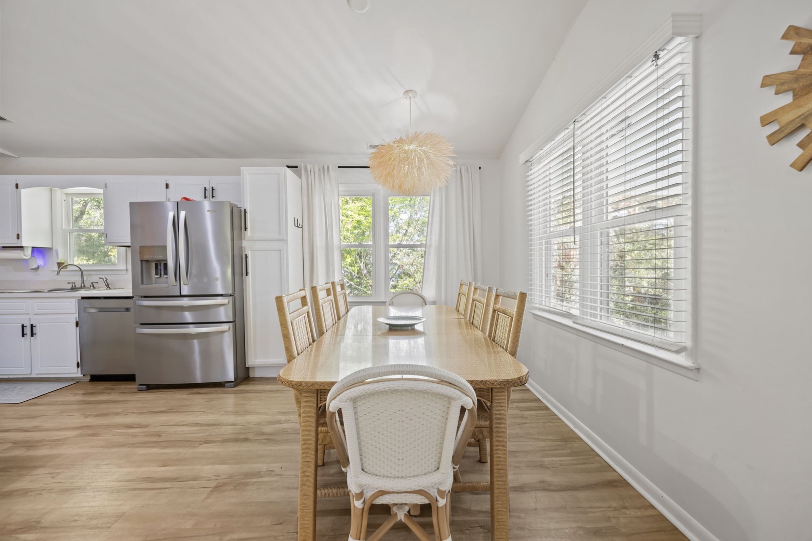 Gather around this beautiful dining table where your group can enjoy meals together in bright, airy comfort with natural light streaming through.
