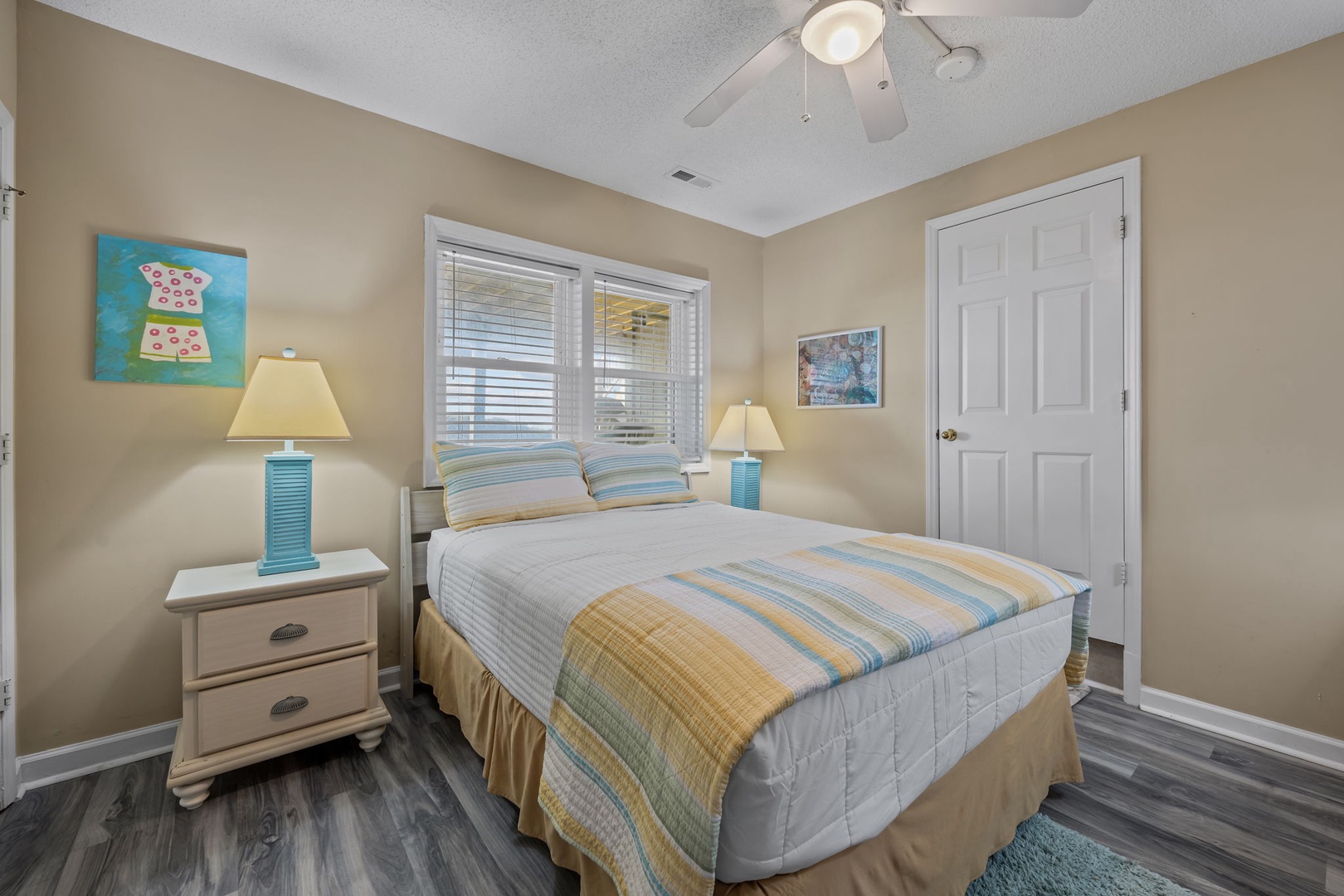 Drift into peaceful dreams in this cozy bedroom with soft coastal colors, comfortable bedding, and gentle natural light filtering through.