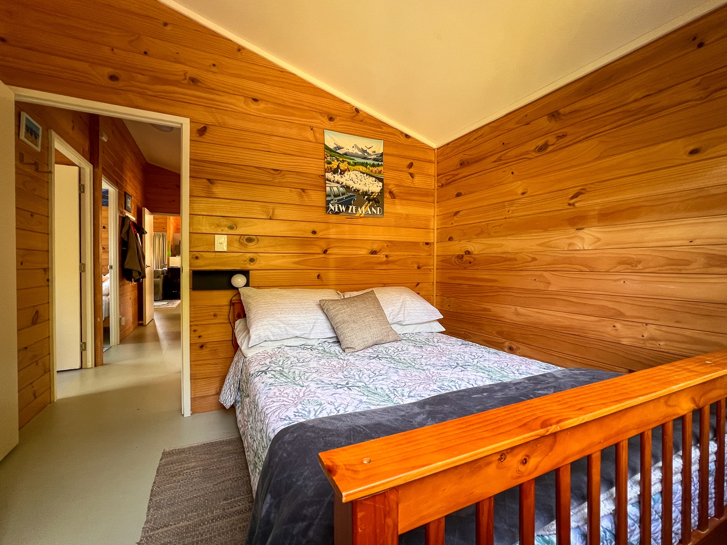 Drift off in your cozy loft bedroom surrounded by warm timber walls and soft linens.