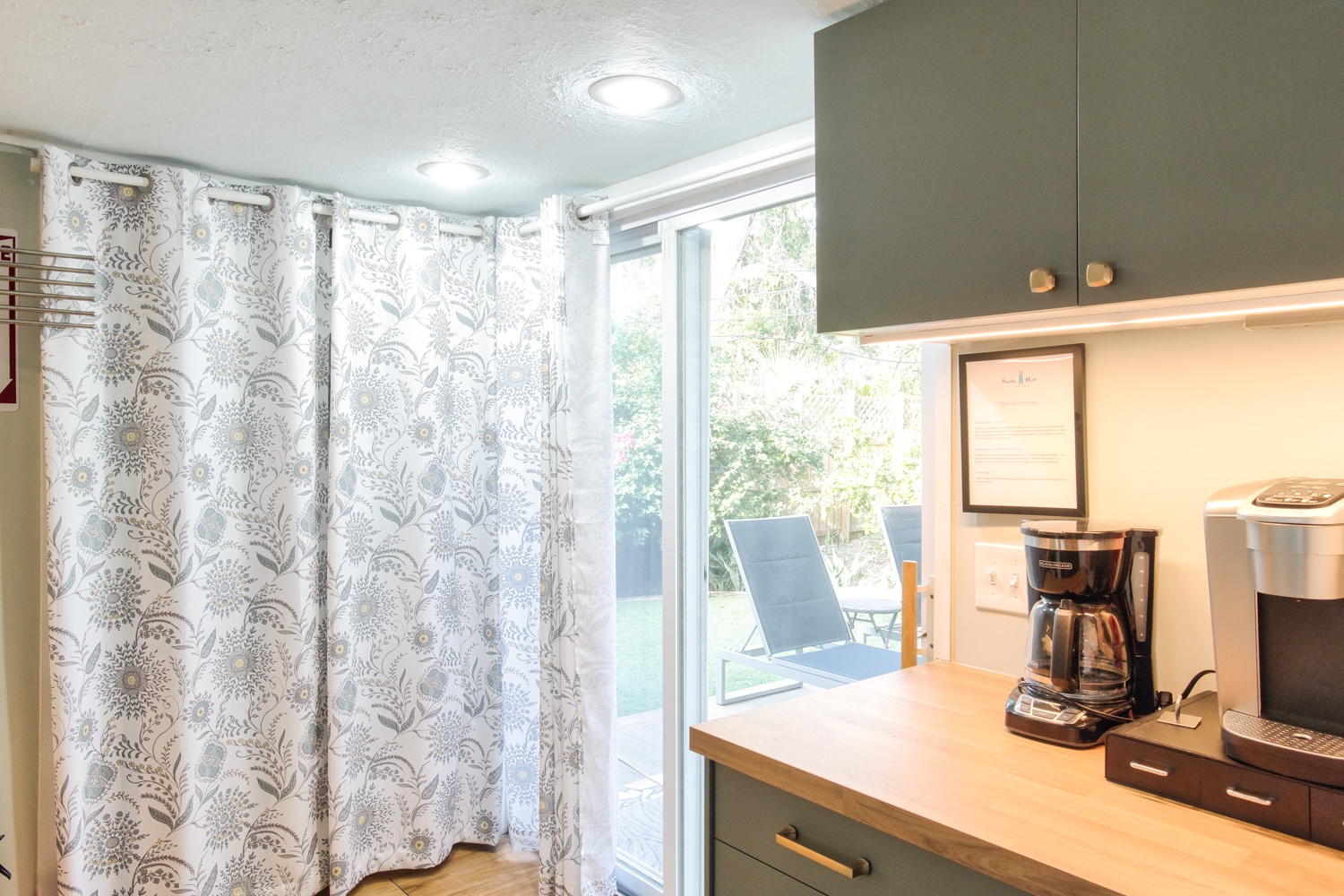 Coffee bar next to the refrigerator (washer and dryer is behind the curtains)