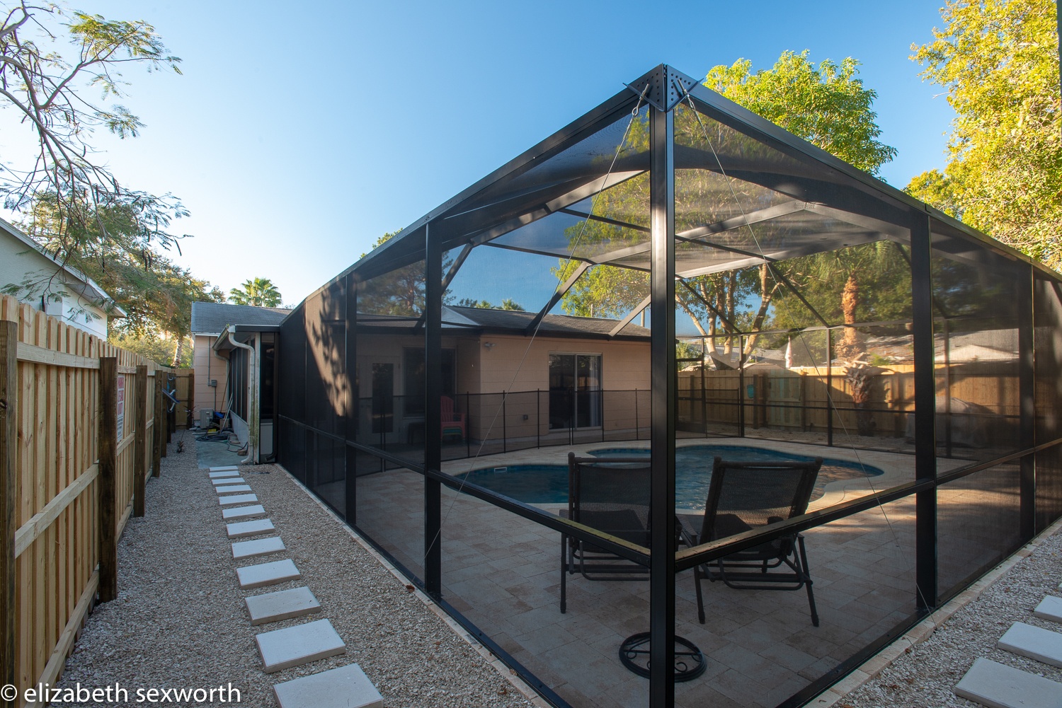 View of pool and pool cage from the shed