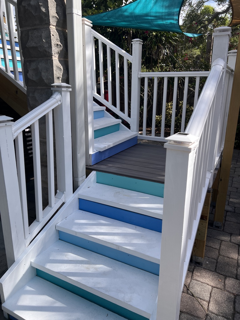 Soak up the sun on your private patio with comfortable loungers and striped cushions, perfect for afternoon relaxation.