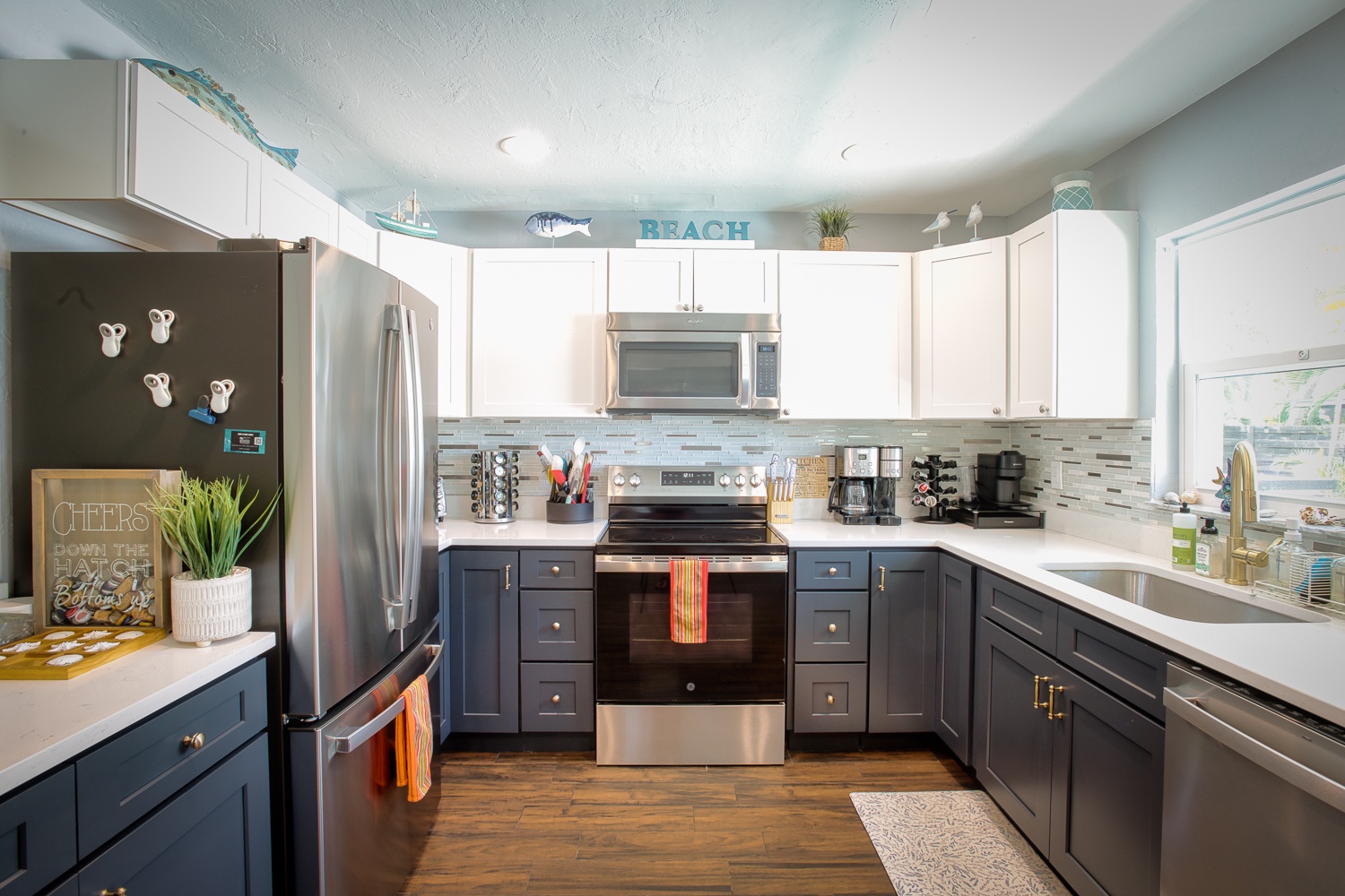 Your fully-equipped kitchen features stainless appliances, coastal decor, and everything needed to prepare meals during your beach getaway.