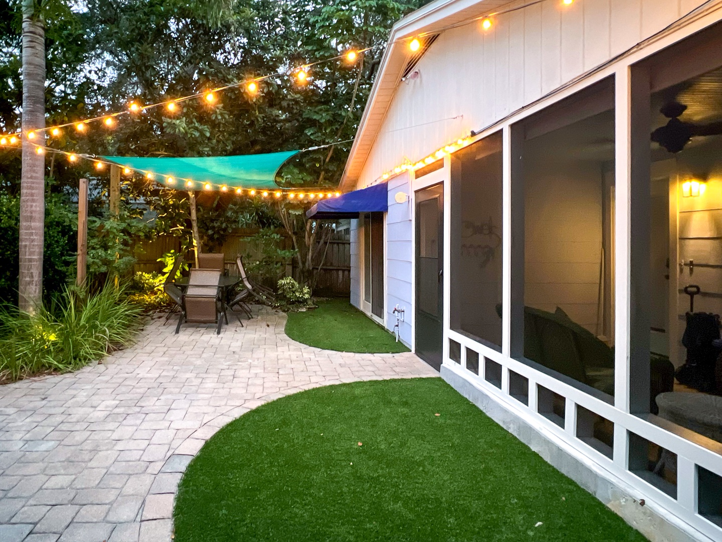 Backyard outside the screened porch - synthetic turf, pavers and landscaping