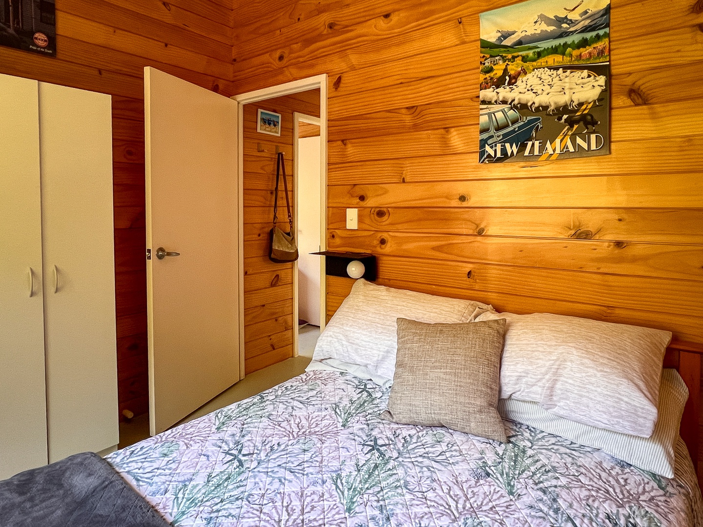 Drift off in your cozy wooden bedroom, where warm timber walls and soft linens create the perfect peaceful retreat.