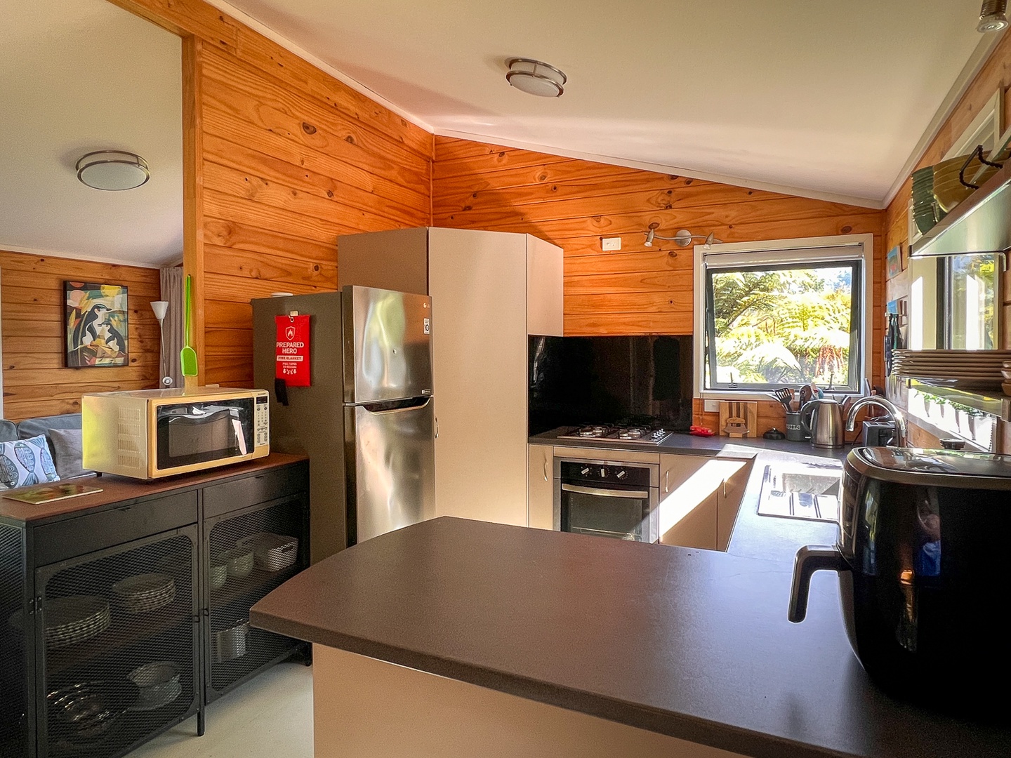 Prepare delicious meals in your fully equipped kitchen featuring modern appliances, warm wood accents, and everything you need for a comfortable stay.