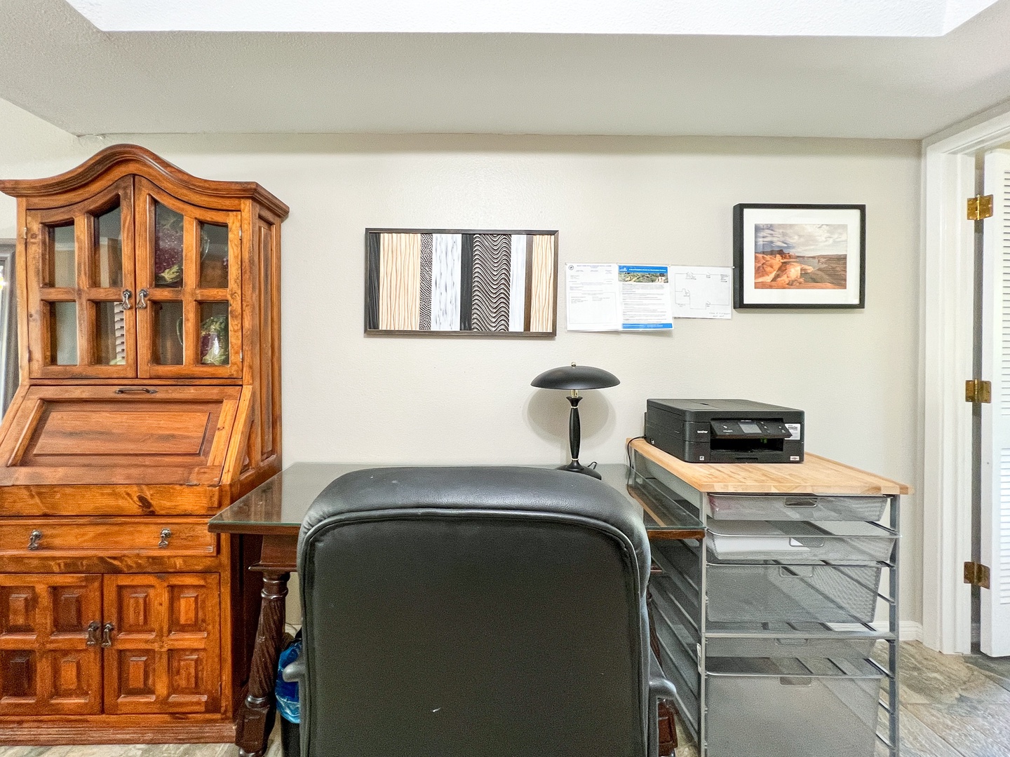 Office has a desk, desk chair, printer