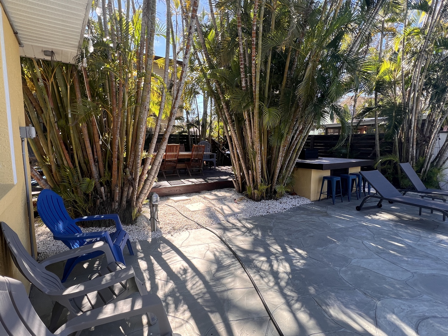Relax in your private tropical oasis with swaying palms creating natural shade over the spacious patio area.