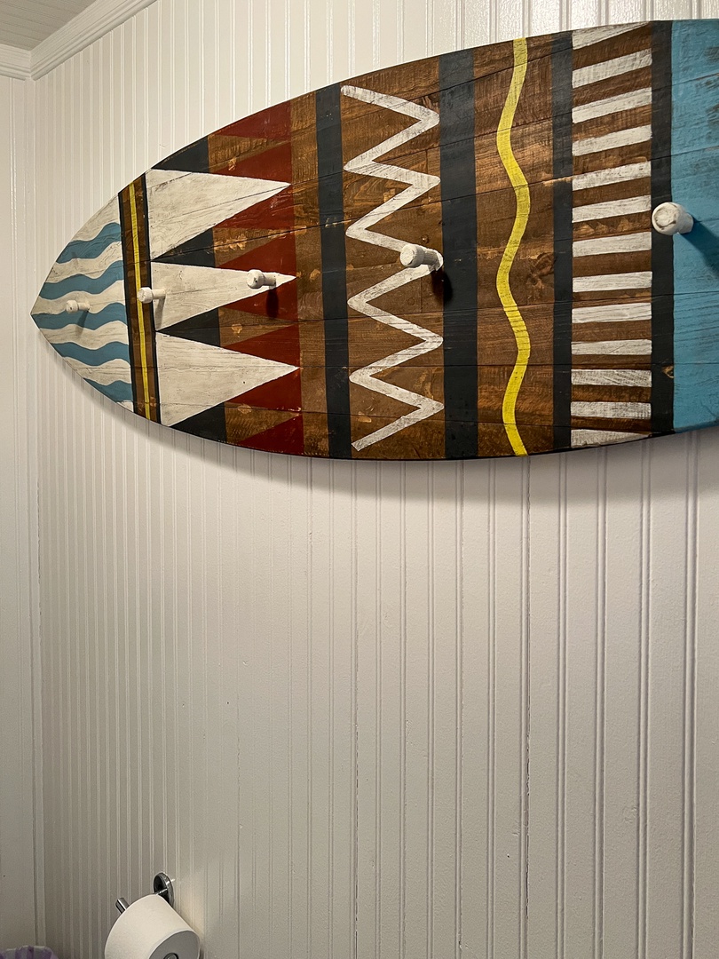 Surf board towel rack