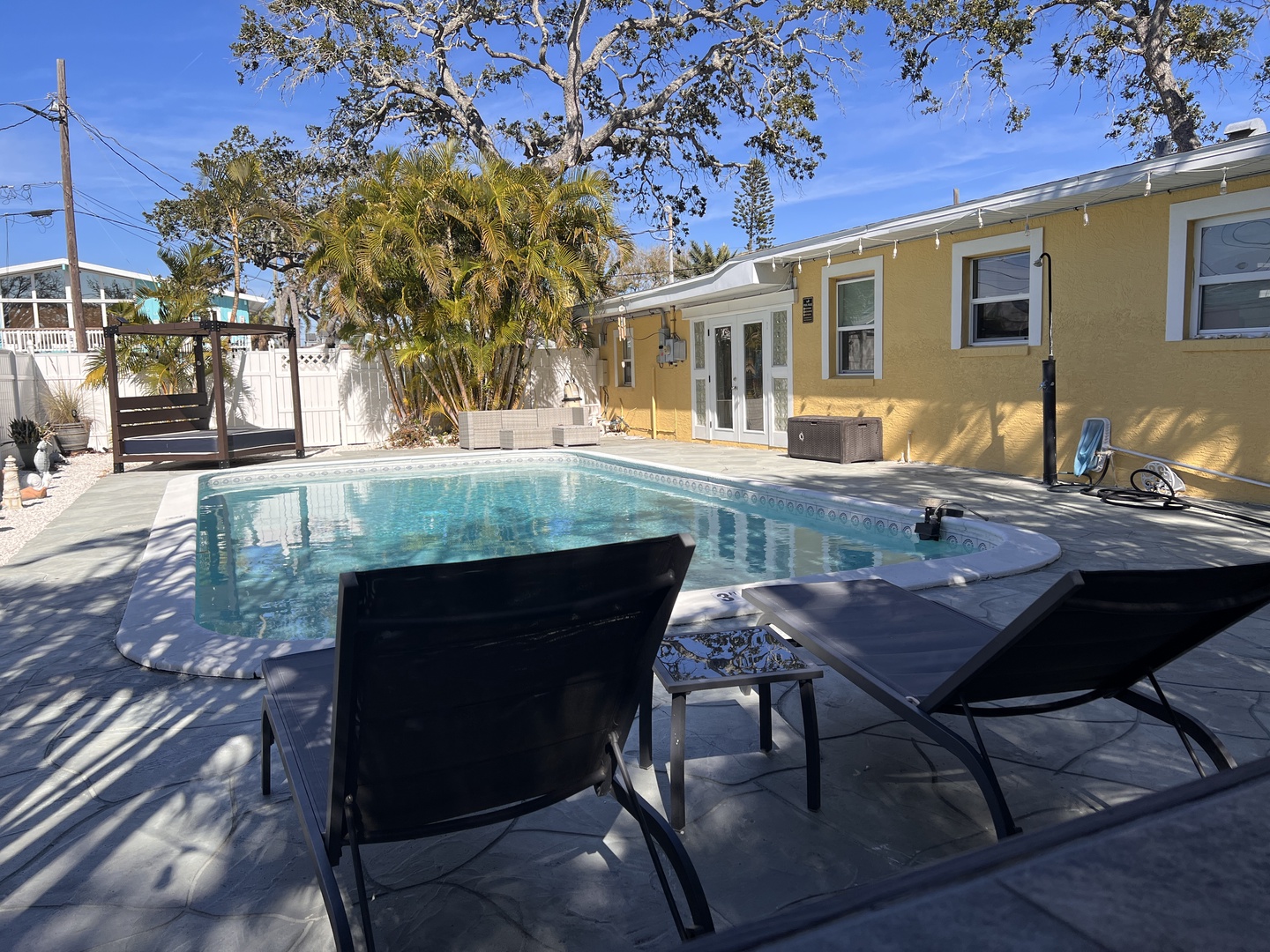 Dive into your private pool oasis surrounded by swaying palms and comfortable loungers for the perfect Florida getaway.