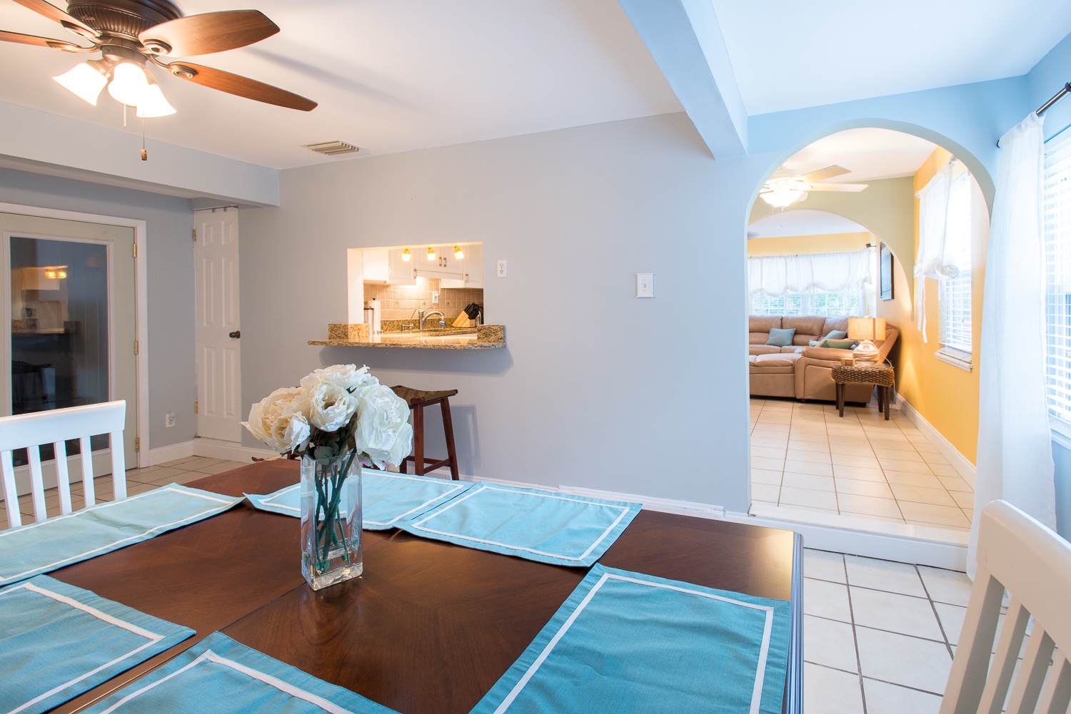 Dining table - pass-through to the kitchen can be seen in this photo along with the living room in the distance